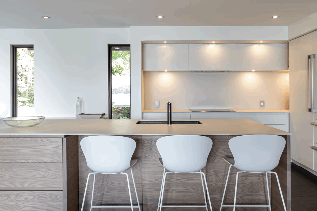 View of a kitchen and island with lighting