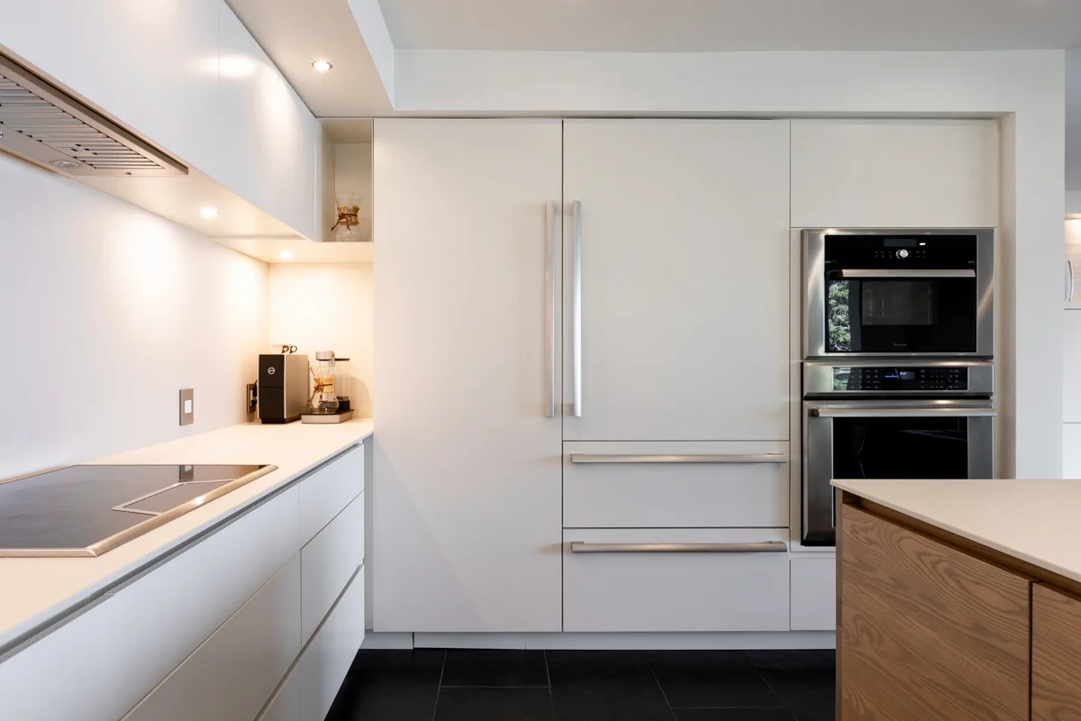 View of a kitchen with a panel-covered electrical panel