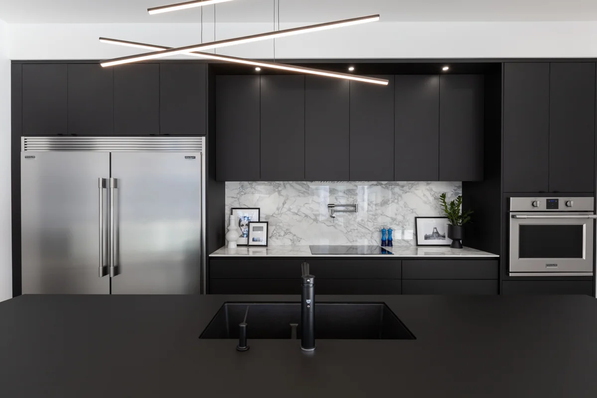 View of a monochrome kitchen with central island