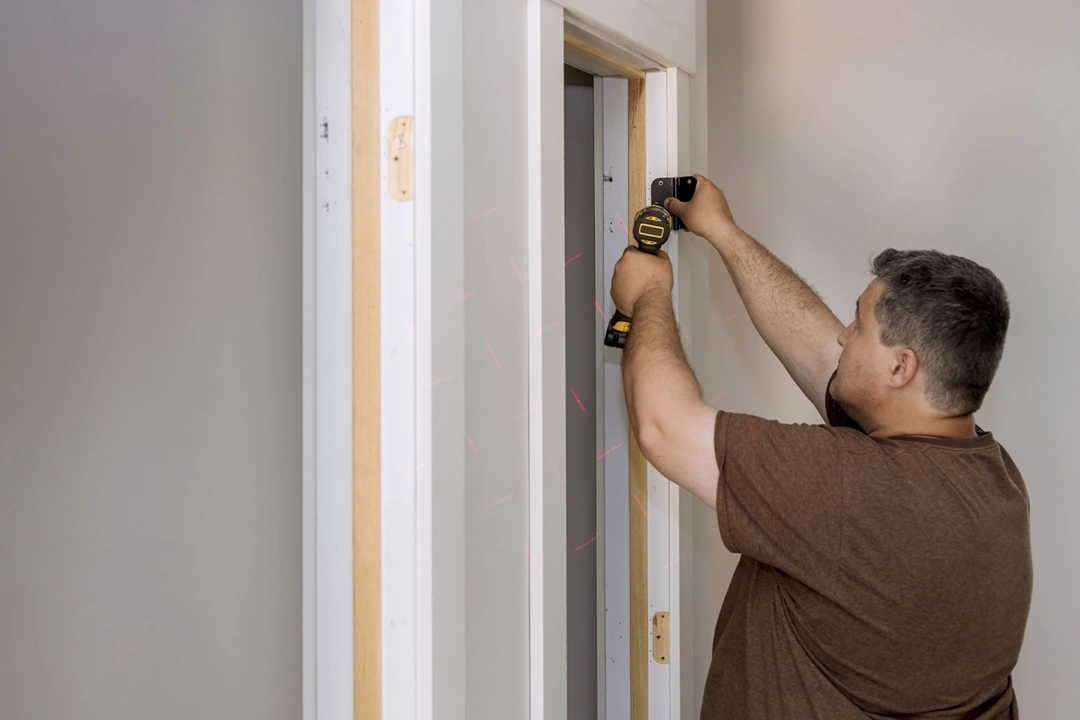 A man staring at a door frame.